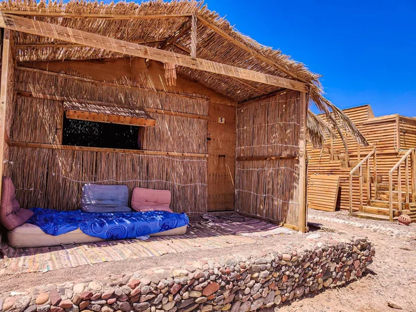 Cottage in a Bedouin Camp on the Sea in Ras Shitan in Oasis in Sinai, Taba desert with the Background of the Sea and Mountains.