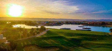 Green Field with the Colorful Sky at Sunset - Showing the amazing colors of the sky at the sunset