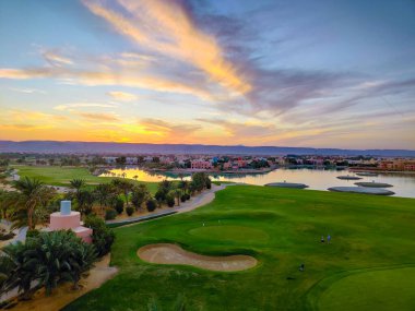 Green Field with the Colorful Sky at Sunset - Showing the amazing colors of the sky at the sunset