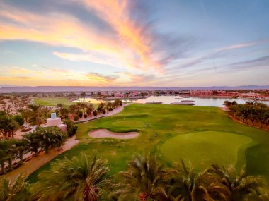 Green Field with the Colorful Sky at Sunset - Showing the amazing colors of the sky at the sunset