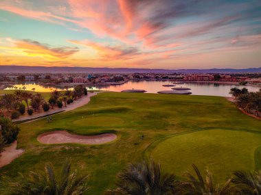 Green Field with the Colorful Sky at Sunset - Showing the amazing colors of the sky at the sunset