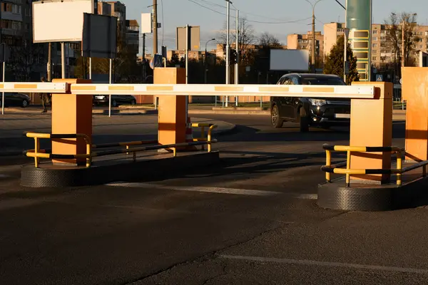 Automatic barrier gates for supermarket parking lot. Vehicle entrance with boom barriers and control tickets machine. Security system for car park entry to shopping mall