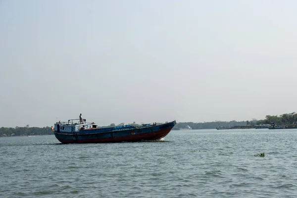 stock image Troller boat on the river delivering goods close-up photo. Beautiful rural area and water vessel transportation. Beautiful sky and river horizon scenery with a motorboat. Restless river and blue sky.