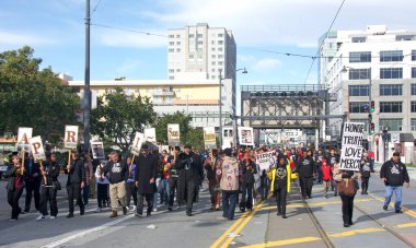 San Francisco, CA - Jan 16, 2023: Unidentified participants in Martin Luther King March from Caltrain station down 4th St over the bridge then up 3rd St over the bridge to Yerba Buena Garden