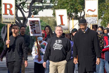 San Francisco, CA - Jan 16, 2023: Unidentified participants in Martin Luther King March from Caltrain station down 4th St over the bridge then up 3rd St over the bridge to Yerba Buena Garden