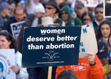 San Francisco, CA - Jan 21, 2023: Unidentified participants in the annual March for Life, holding pro-life signs and banners, walking down Market street towards the Embarcadero
