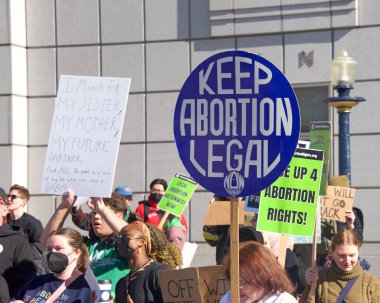 San Francisco, CA - Jan 21, 2023: Unidentified pro-choice counter protestors at the annual March for Life, holding pro-choice signs and banners across from Civic Center