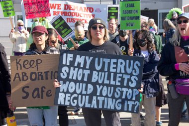 San Francisco, CA - Jan 21, 2023: Unidentified pro-choice counter protestors at the annual March for Life, holding pro-choice signs and banners across from Civic Center