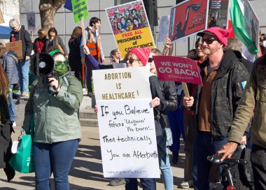 San Francisco, CA - Jan 21, 2023: Unidentified pro-choice counter protestors at the annual March for Life, holding pro-choice signs and banners across from Civic Center