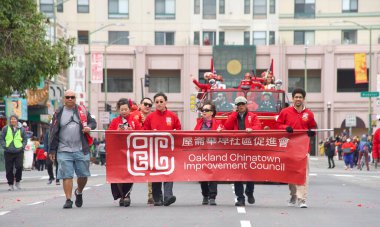 Oakland, CA - Jan 29, 2023: Participants in the first annual Lunar New Year Parade in Oakland. Chinatown Improvement Council members walking holding a banner.