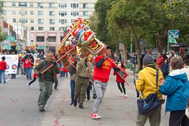 Oakland, CA - Jan 29, 2023: Participants in the first annual Lunar New Year Parade in Oakland. Boy Scouts with dragon dance performing for the crowd