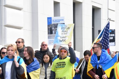 San Francisco, CA - Feb 25, 2023: Participants at Unite for Ukraine March from Harry Bridges Plaza on the Embarcadero to Pier 39.