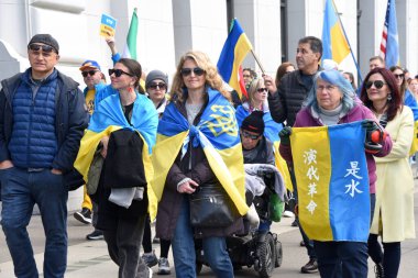 San Francisco, CA - Feb 25, 2023: Participants at Unite for Ukraine March from Harry Bridges Plaza on the Embarcadero to Pier 39.