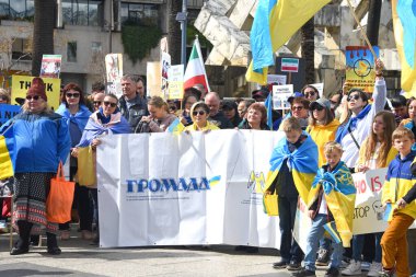 San Francisco, CA - Feb 25, 2023: Participants at Unite for Ukraine Rally at Harry Bridges Plaza on the Embarcadero, organized by the Ukrainian American Coordinating council.