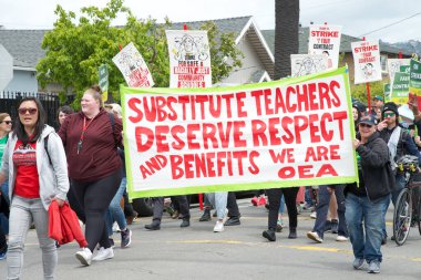 Oakland, CA - 8 Mayıs 2023: Yüzlerce öğretmen, veli ve destekçi Oakland 'ın dağlık kesiminde düzenlenen bir grev mitinginde yürüyor.