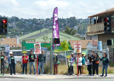 Oakland, CA - 9 Mayıs 2023: Öğretmenler, Aileler ve Destekçiler, 73. Cadde ile Uluslararası Bulvar 'ın köşesindeki öğretmen grevi gününde ellerinde pankart ve pankart tutuyorlar