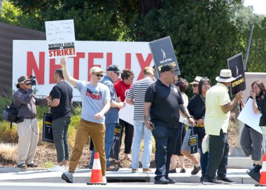 Los Gatos, CA - Aug 22, 2023: Northern California local members of SAG-AFTRA strike in solidarity with the Writers Guild of America in front of the Netflix building on Winchester Blvd clipart