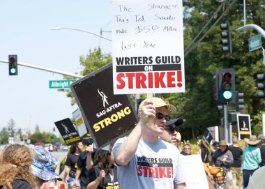 Los Gatos, CA - Aug 22, 2023: Northern California local members of SAG-AFTRA strike in solidarity with the Writers Guild of America in front of the Netflix building on Winchester Blvd clipart