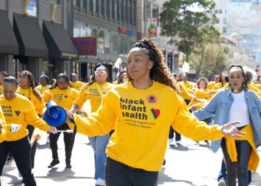 Oakland, CA - Feb 25, 2024: Unidentified partiipants in the 7th annual Black Joy Parade in Oakland, CA. clipart