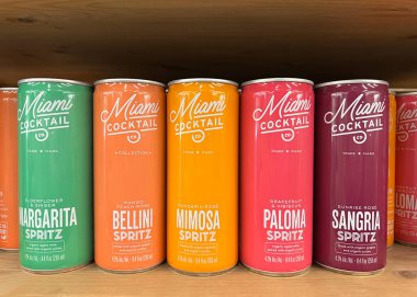 Oakland, CA - July 1, 2022: Grocery Store shelf with personal sized cans of Miami Cocktail Co alcoholic beverages. margarita, Bellina, Mimosa, Paloma and Sangria. clipart