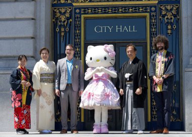 San Francisco, CA - April 21, 2024: Parade Grand Marshal Hello Kitty posing for photos in front of City Hall with the consul general of Japan, his wife. and Supervisor Dean Preston and organizers clipart