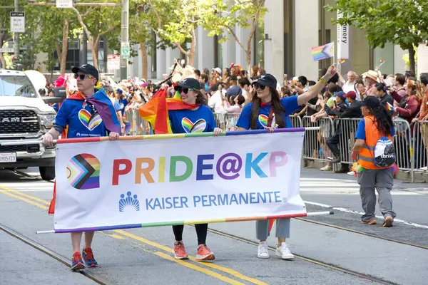 Stock image San Francisco, CA - June 30, 2024:  Unidentified partiipants in  the 54th annual Gay Pride Parade going up Market. This years theme, Beacon of Love.