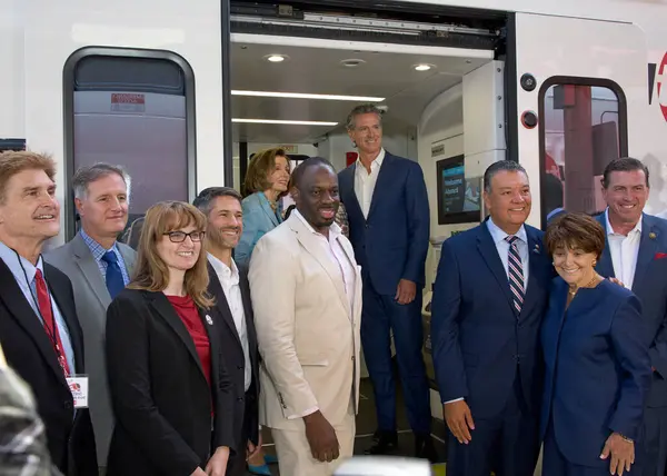 Stock image San Francisco, CA - Aug 10, 2024:  Emerita Nancy Pelosi and Governor Newsom cutting the ribbon at a press event to celebrate Caltrains First Electric Train Ride. 