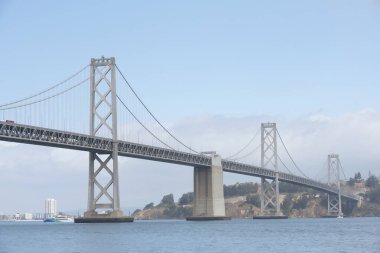 San Francisco, CA - Sept 16, 2024: West end of the Bay Bridge heading into Downtown San Francisco, Treasure Island and Yerba Buena Island in the background. clipart