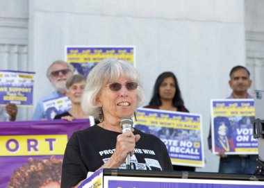 Oakland, CA - Oct 20, 2024: Rivka Polatnick speaking outside the Alameda County Courthouse at a Rally to Protect the win, vote no on the recall initiative. clipart