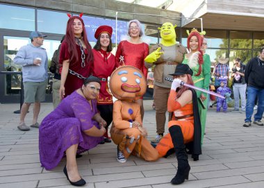 Half Moon Bay, CA - 19 Ekim 2024: 52. Yıllık Sanat ve Balkabağı Festivali katılımcıları. Kostümlü yarışmacılar kütüphanenin önünde yarışıyorlar..