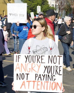 San Francisco, CA - Jan 18, 2024: Unidentified participants in the Peoples March, calling for reproductive rights and other causes they feel are threatened by the incoming Trump Administration.  clipart