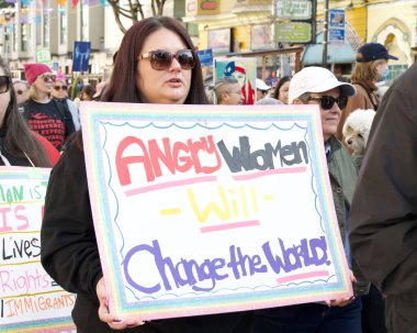 San Francisco, CA - Jan 18, 2024: Unidentified participants in the Peoples March, calling for reproductive rights and other causes they feel are threatened by the incoming Trump Administration.  clipart