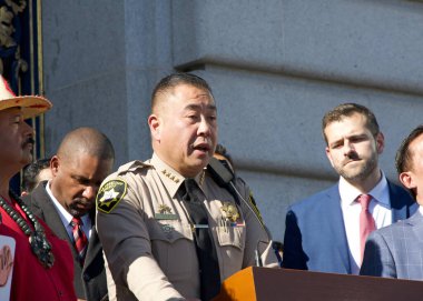 San Francisco, CA - Jan 28, 2025: Sheriff Paul Miyamoto speaking on the steps outside of City Hall re-affirming the cities ongoing status as a Sanctuary City clipart