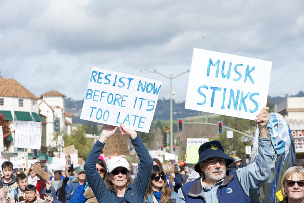 Oakland, CA - Feb 17, 2025: Unidentified participants in a Not My Presidents Day protest and march and rally from the Fruitvale Bart to Lake Merritt.