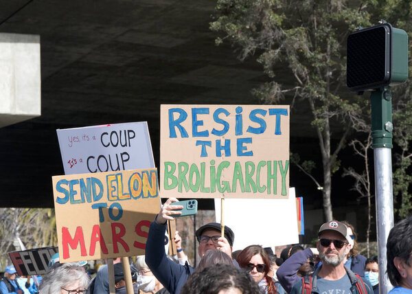 Oakland, CA - Feb 17, 2025: Unidentified participants in a Not My Presidents Day protest and march and rally from the Fruitvale Bart to Lake Merritt. 