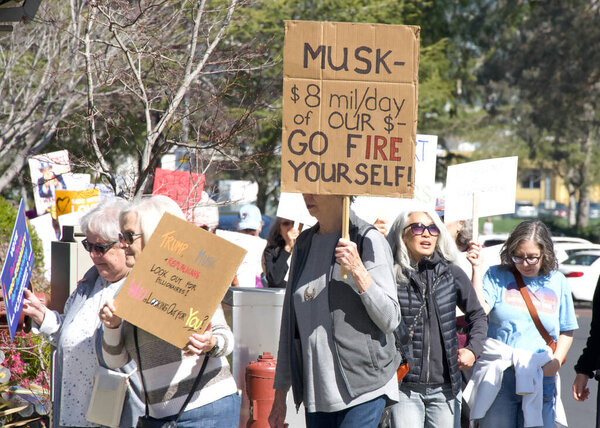 Corte Madera, CA - March 8, 2025: Participants in an International Women's Day Protest. Calling for equal pay, reproductive rights, education and justice among other topics. 