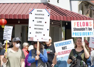 Alameda, CA - 5 Nisan 2025: Kimliği belirsiz katılımcılar OFF, Kaldır, Geri Al, Geri Al protestosu, Park Caddesi 'nde yürüyüş. Mevcut yönetimi protesto etmek.