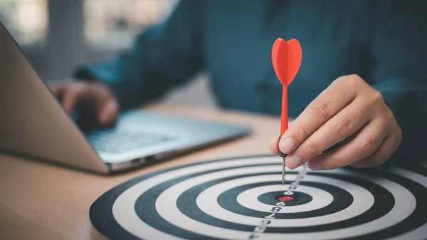 New Targeting with marketing business concept, Businessman hand holding red dart to the virtual target dartboard, Executive marketing, investment goal and target for business investment concept,