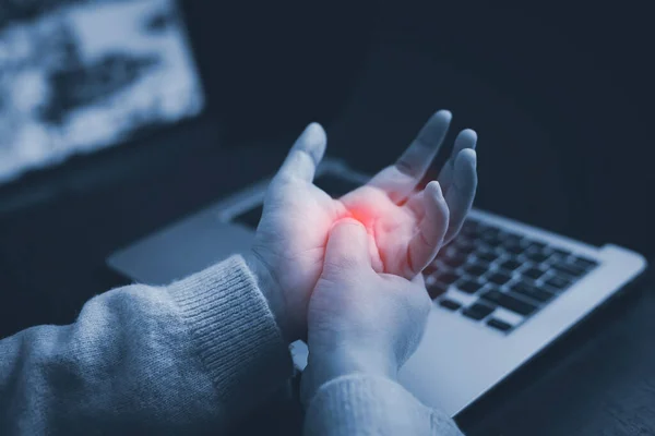 Office syndrome with hand pain by occupational disease, Woman holding her hand pain from using laptop or smartphone long time,Health care and medical concept, wrist pain.