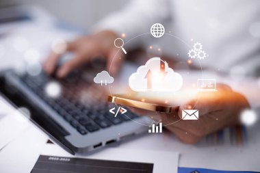 Businessman hand holding smartphone and laptop with cloud computing diagram show on hand. Cloud technology. Data storage. Networking and internet service concept, Cloud sharing download and upload