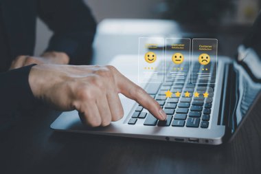 Businessman pressing smile on laptop keyboard customer service, evaluation concept,rating to service experience on online application, Customer review satisfaction feedback survey,Negative feedback 