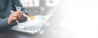 Businessman using a laptop with online shopping concept, marketplace website with virtual interface of online Shopping cart part of the network, Online shopping business with selecting shopping cart.