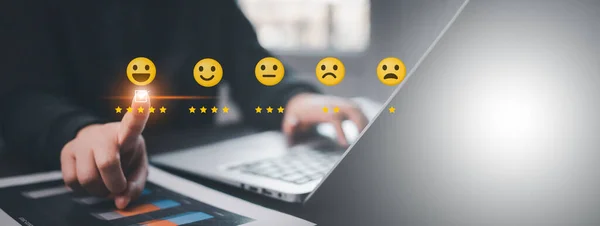 Businessman pressing smile on laptop with customer service, evaluation, best excellent business rating experience. Satisfaction survey, user give rating to service experience on online application