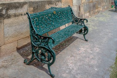 09 27 2009 Vintage Cast Iron Garden Bench at Qutub Minar complex a UNESCO world Heritage Site Mehrauli, New Delhi India