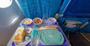 09 13 2007 selective focus In Flight meal service tray for economy class; meal; fruit; salad; cucumber; a glass of juice and butter. fork knife made of plastic Sri Lanka Asia.