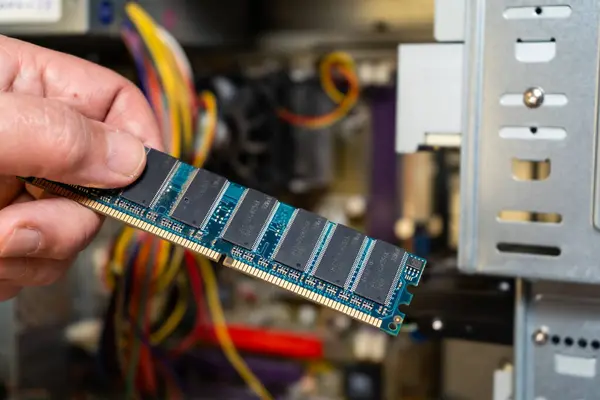 stock image A hand of a technician showing a computer's RAM memory bank.