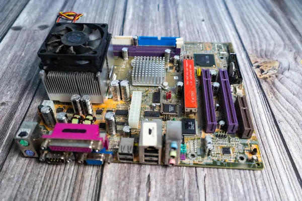 stock image A PC motherboard on a wooden table.