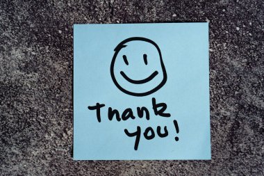 Thank you words written on a post-it or note. clipart