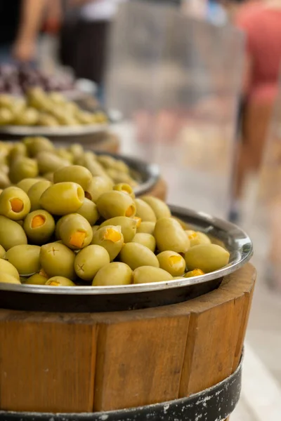 Different marinated olives and local food on street market in Gdansk, Poland. Selling and buying street food. Assortment of Appetizing olives on market. Tourist attraction