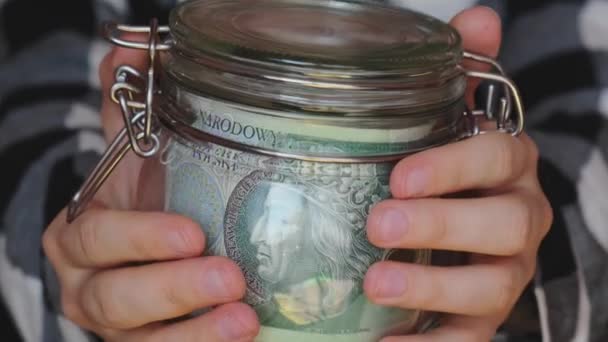 Polish Zloty Banknote Saving Money Glass Jar Unrecognizable Woman Moderate — Stockvideo